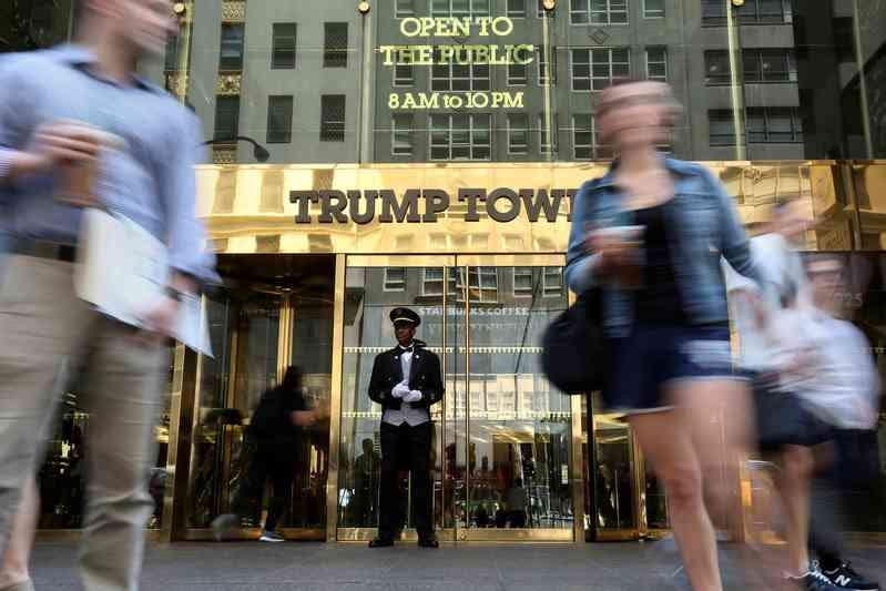 A doorman stands as people walk past the Trump Tower in New York, U.S., May 23, 2016.  REUTERS/Carlo Allegri/File Photo