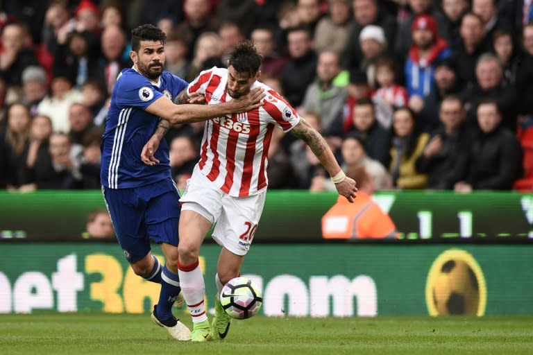 Chelsea's Diego Costa (L) fights for the ball with Stoke City's Geoff Cameron during their English Premier League match, at the Bet365 Stadium in Stoke-on-Trent, on March 18, 2017