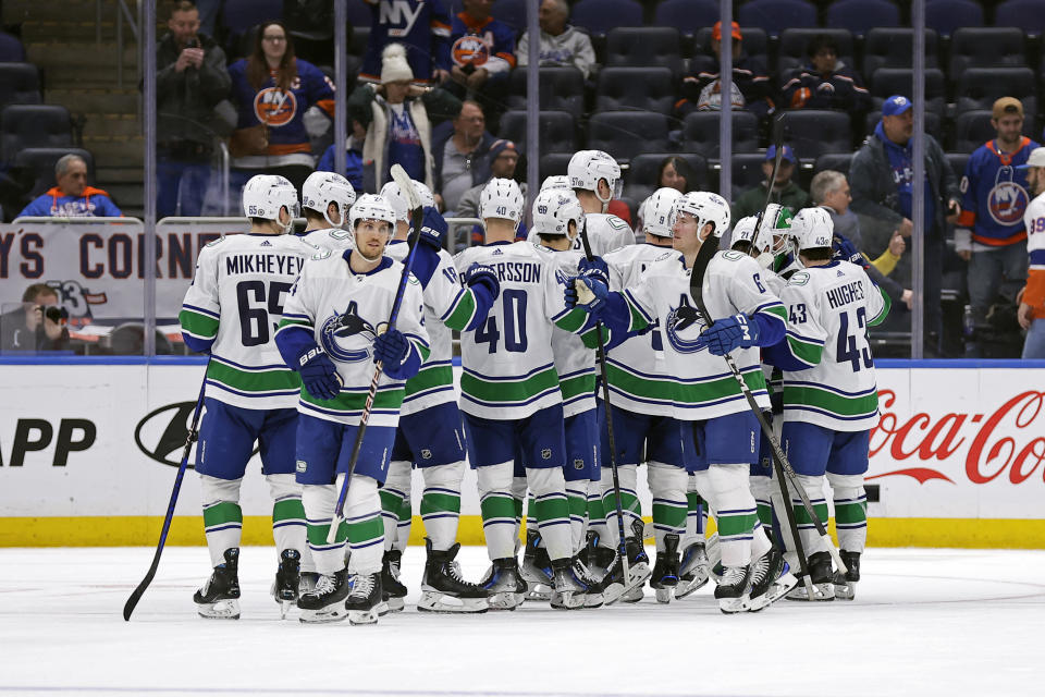 The Vancouver Canucks celebrate after defeating the New York Islanders in an NHL hockey game Tuesday, Jan. 9, 2024, in Elmont, N.Y. The Canucks won 5-2. (AP Photo/Adam Hunger)