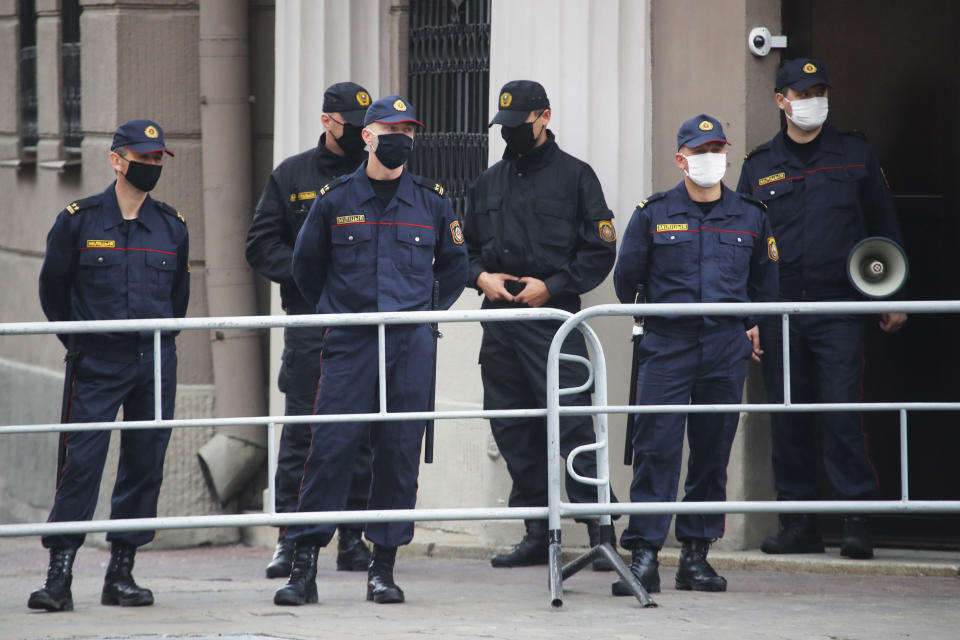 Police block a sidewalk area next to Ministry of Internal Affairs of Belarus in Minsk, Belarus, Wednesday, Aug. 19, 2020. The authoritarian leader of Belarus complained that encouragement from abroad has fueled daily protests demanding his resignation as European Union leaders held an emergency summit Wednesday on the country's contested presidential election and fierce crackdown on demonstrators. (AP Photo/Dmitri Lovetsky)