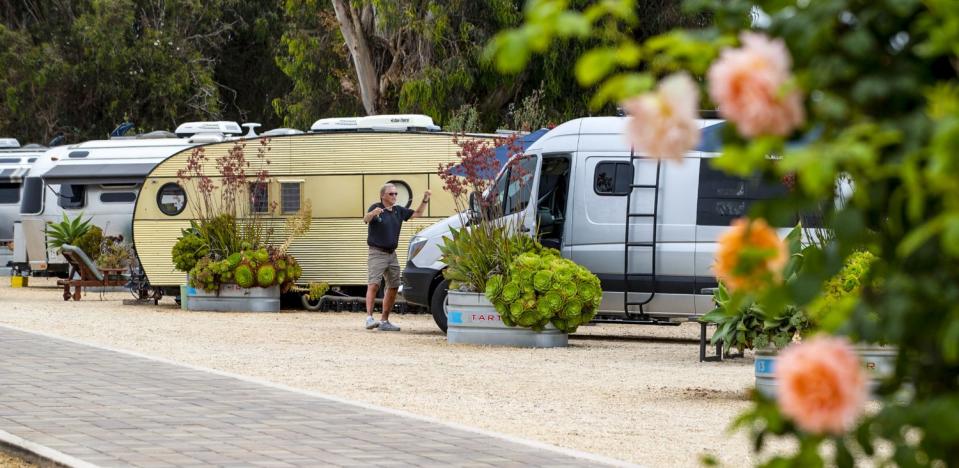 A guest hangs lights on their van.