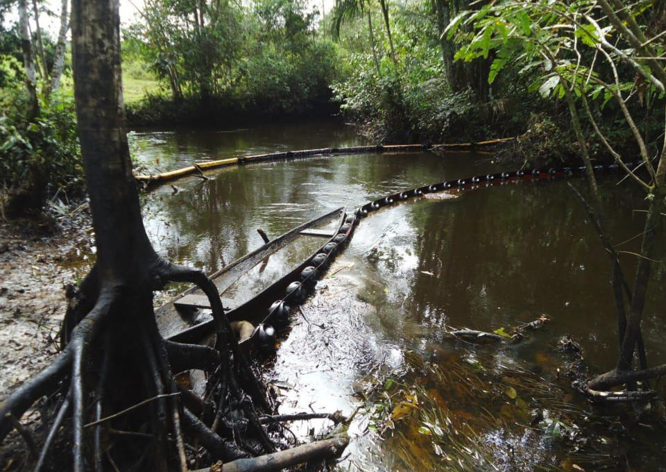 This June 2015 photo provided by the Justice and Peace Commission shows an oil spill on the Chufiya river, in the Putumayo region of Colombia. The British law firm Leigh Day said it is suing Amerisur, the oil company operating in the region, on behalf of more than 170 Putumayo farmers. That spill was not the only complication with this particular oil operation. (Justice and Peace Commission via AP)