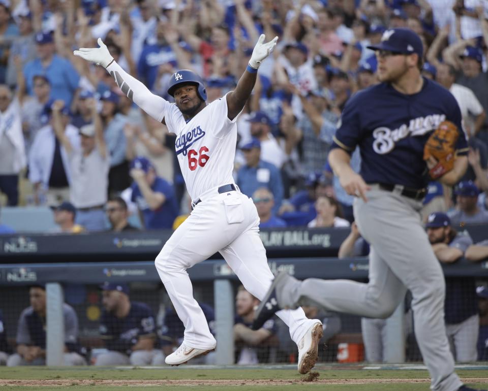 Los Angeles Dodgers' Yasiel Puig reacts after hitting an RBI single during the sixth inning of Game 5 of the National League Championship Series baseball game against the Milwaukee Brewers Wednesday, Oct. 17, 2018, in Los Angeles. (AP Photo/Jae Hong)