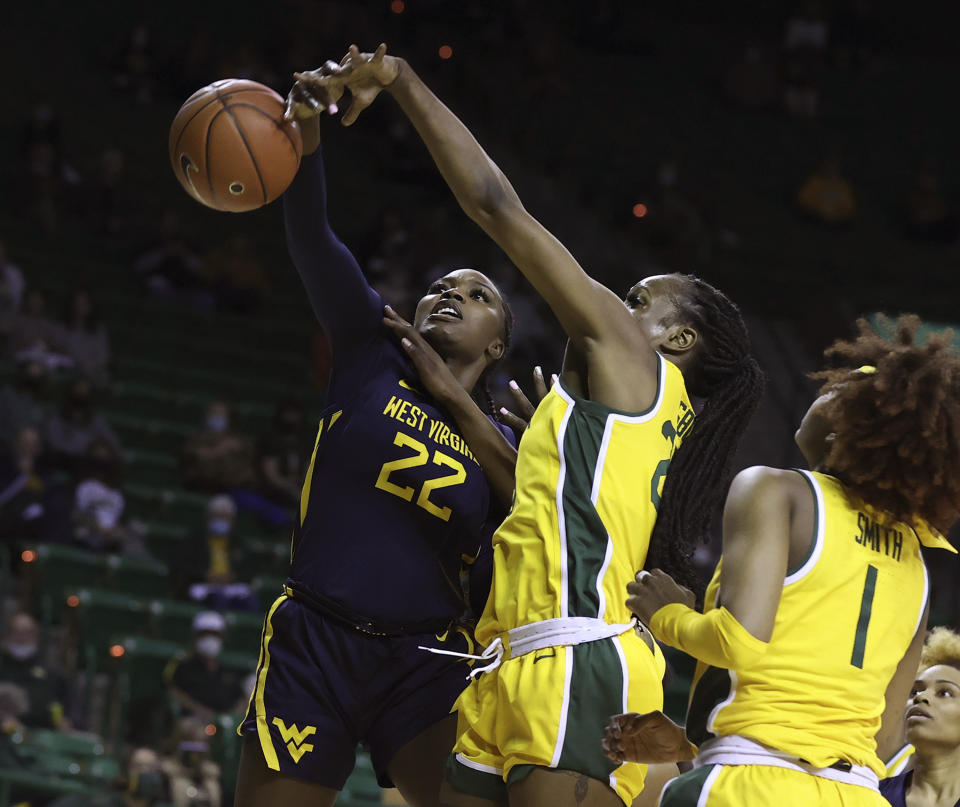Baylor center Queen Egbo, center right, defends the shot of West Virginia center Blessing Ejiofor, left, in the first half of an NCAA college basketball game, Monday, March 8, 2021, in Waco, Texas. (Rod Aydelotte/Waco Tribune-Herald via AP)