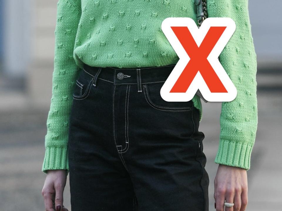 woman wearing green sweater and black high waisted jeans