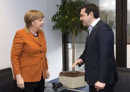 Germany's Chancellor Angela Merkel meets Greece's Prime Minister Alexis Tsipras (R) during a EU-Turkey summit in Brussels, as the bloc is looking to Ankara to help it curb the influx of refugees and migrants flowing into Europe, March 7, 2016. REUTERS/John Thys/Pool