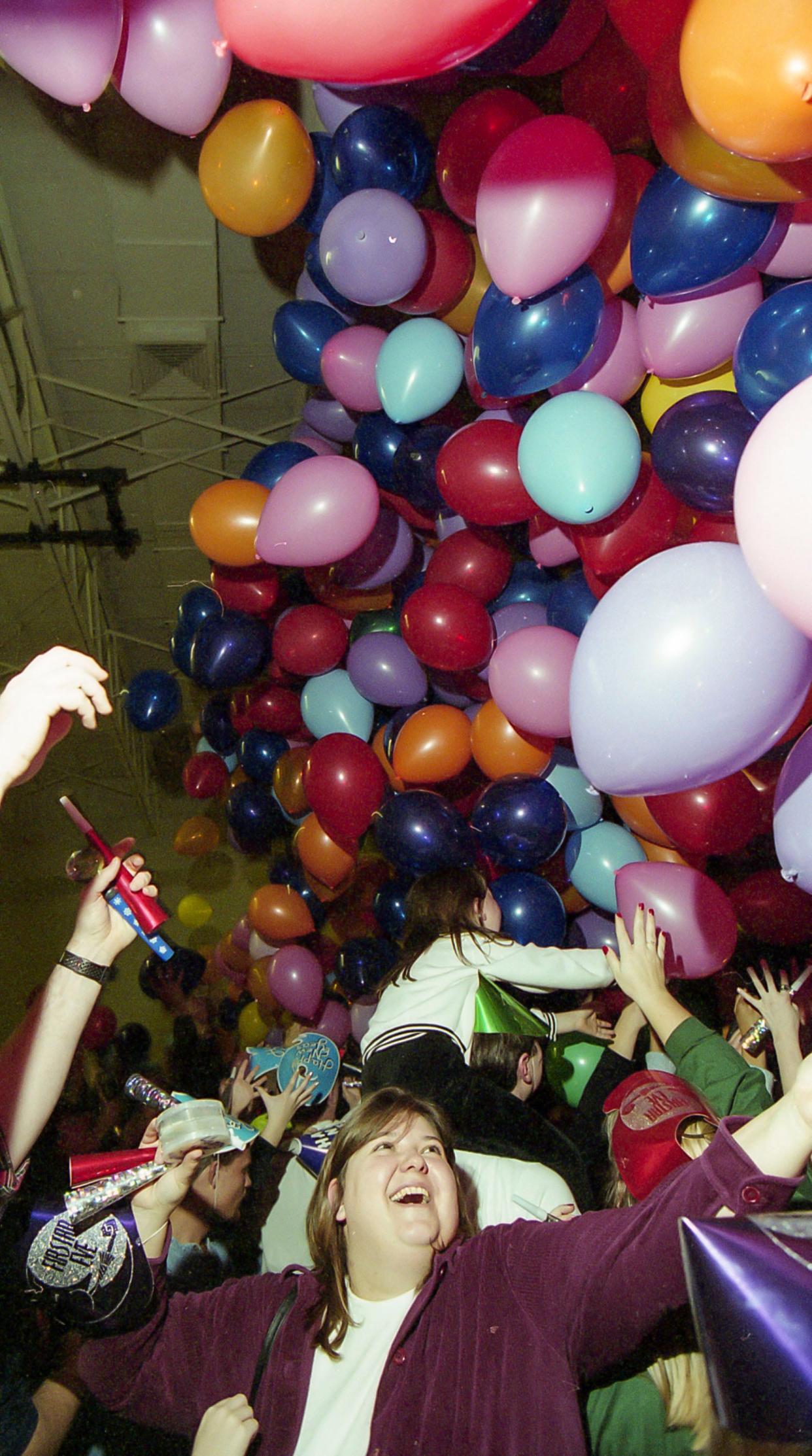 Outstretched arms greet falling balloons at First Star Eve, Saturday, January 1, 2000 at Horace Mann School, in Sheboygan, Wis.