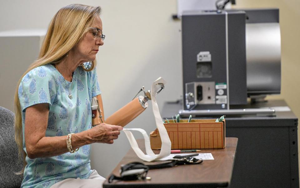 Miriam Wooten looks at printed voting information as it arrived at the Anderson County voter registration elections in Anderson, SC, Tuesday, June 11, 2024.
