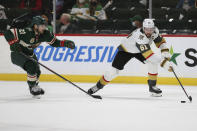 Vegas Golden Knights' Mark Stone (61) controls the puck next to Minnesota Wild's Carson Soucy (21) during the second period in Game 3 of a first-round NHL hockey playoff series Thursday, May 20, 2021, in St. Paul, Minn. (AP Photo/Stacy Bengs)