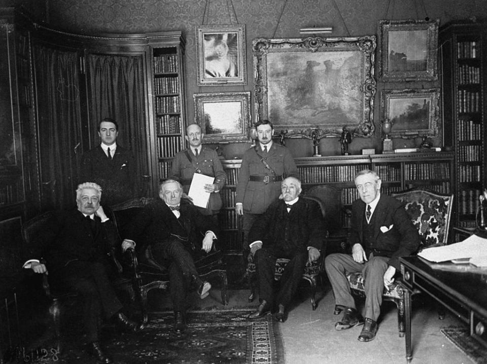 1919 Peace Conference attendees (seated, L-R) Italian Premier Vittorio Orlando, British Prime Minister David Lloyd George, French Premier Georges Clemenceau, U.S. President Woodrow Wilson meeting in Paris prior to the signing of the Versailles Treaty. | US Army Signal Corps/The LIFE Picture Collection—Getty Images