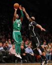 Nov 14, 2017; Brooklyn, NY, USA; Boston Celtics point guard Kyrie Irving (11) shoots over Brooklyn Nets power forward Trevor Booker (35) during the fourth quarter at Barclays Center. Mandatory Credit: Brad Penner-USA TODAY Sports