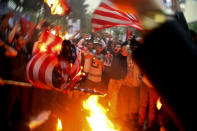 FILE - Iranian demonstrators burn representations of the U.S. flag during a protest in front of the former U.S. Embassy in response to President Donald Trump's decision Tuesday to pull out of the nuclear deal and renew sanctions, in Tehran, Iran, Wednesday, May 9, 2018. Iran and world powers resume talks in Vienna this week of Nov. 28, 2021, aimed at restoring the nuclear deal that crumbled after the U.S. pulled out three years ago. There are major doubts over whether the deal can be reinstated after years of mounting distrust. (AP Photo/Vahid Salemi, File)