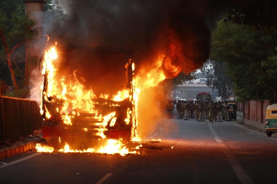 A passenger bus goes up in flames during a protest against Citizenship Amendment Act in New Delhi, India, Sunday, Dec. 15, 2019. Protests have been continuing over a new law that grants Indian citizenship based on religion and excludes Muslims. (AP Photo)