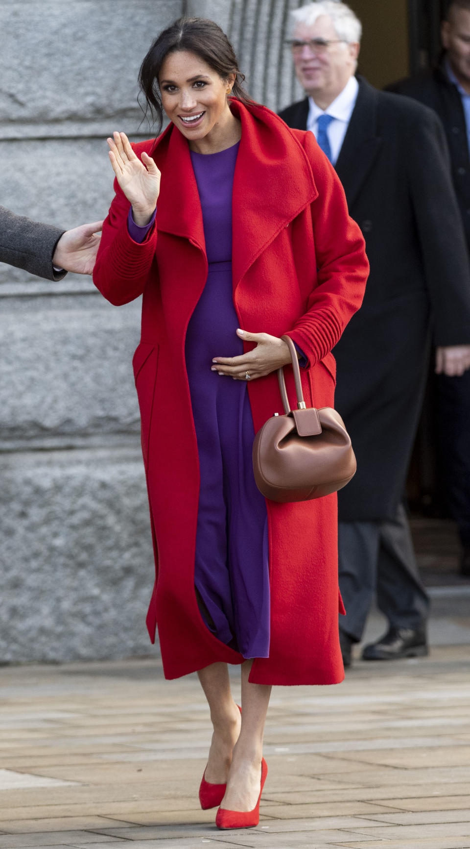 One of our favourite looks to date was this colour-blocking ensemble by Meghan's go-to Canadian labels. Kick-starting 2019 in style, the Duchess of Sussex broke her navy streak in a traffic light red Sentaler coat teamed with a purple midi dress by Aritzia’s Babaton. Clashing Stuart Weitzman heels finished the look. <em>[Photo: Getty]</em>