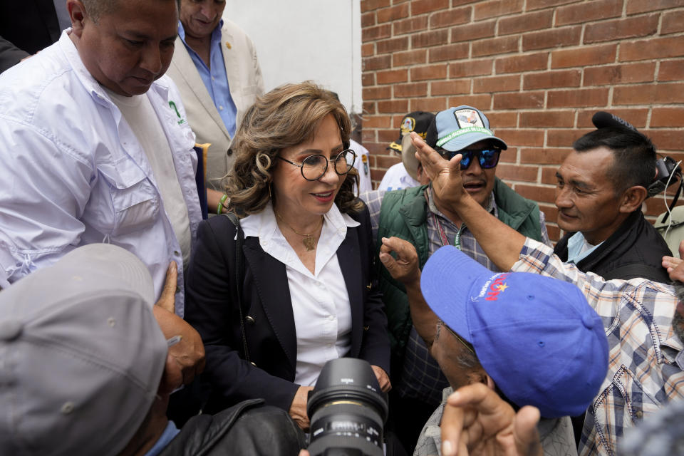 Guatemalan Army veterans greet UNE party presidential candidate Sandra Torres after a meeting in Guatemala City, Tuesday, Aug. 15, 2023. Torres will face Bernardo Arévalo of the Seed Movement party in an Aug. 20 runoff election. (AP Photo/Moises Castillo)