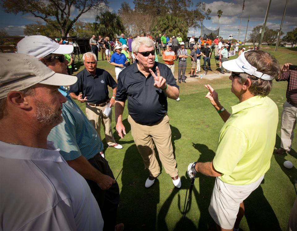 Andy Bean (left, with sunglasses) talks golf with former University of Florida football coach Steve Spurrier during a charity tournament in Lakeland in 2017.