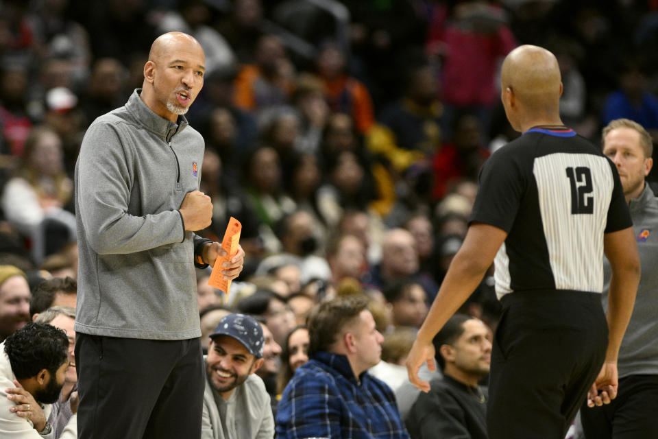 Phoenix Suns head coach Monty Williams, left, reacts to referee CJ Washington (12) during the first half of an NBA basketball game against the Washington Wizards, Wednesday, Dec. 28, 2022, in Washington. (AP Photo/Nick Wass)