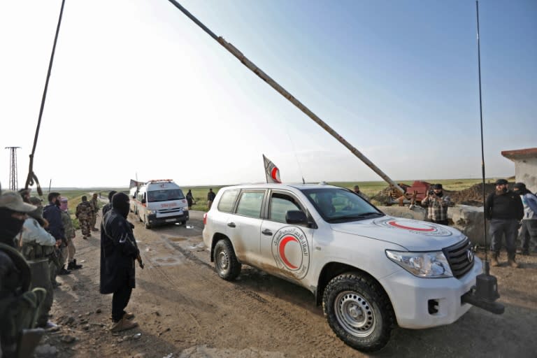 A file picture shows a convoy transporting civilians from the besieged Shiite areas of Fuaa and Kafraya in rebel-held northwestern Syria arriving at the Al-Eis crossing on May 1, 2018