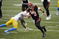 Cincinnati Bengals quarterback Joe Burrow (9) runs past Los Angeles Chargers' Rayshawn Jenkins (23) for a touchdown during the first half of an NFL football game, Sunday, Sept. 13, 2020, in Cincinnati. (AP Photo/Bryan Woolston)