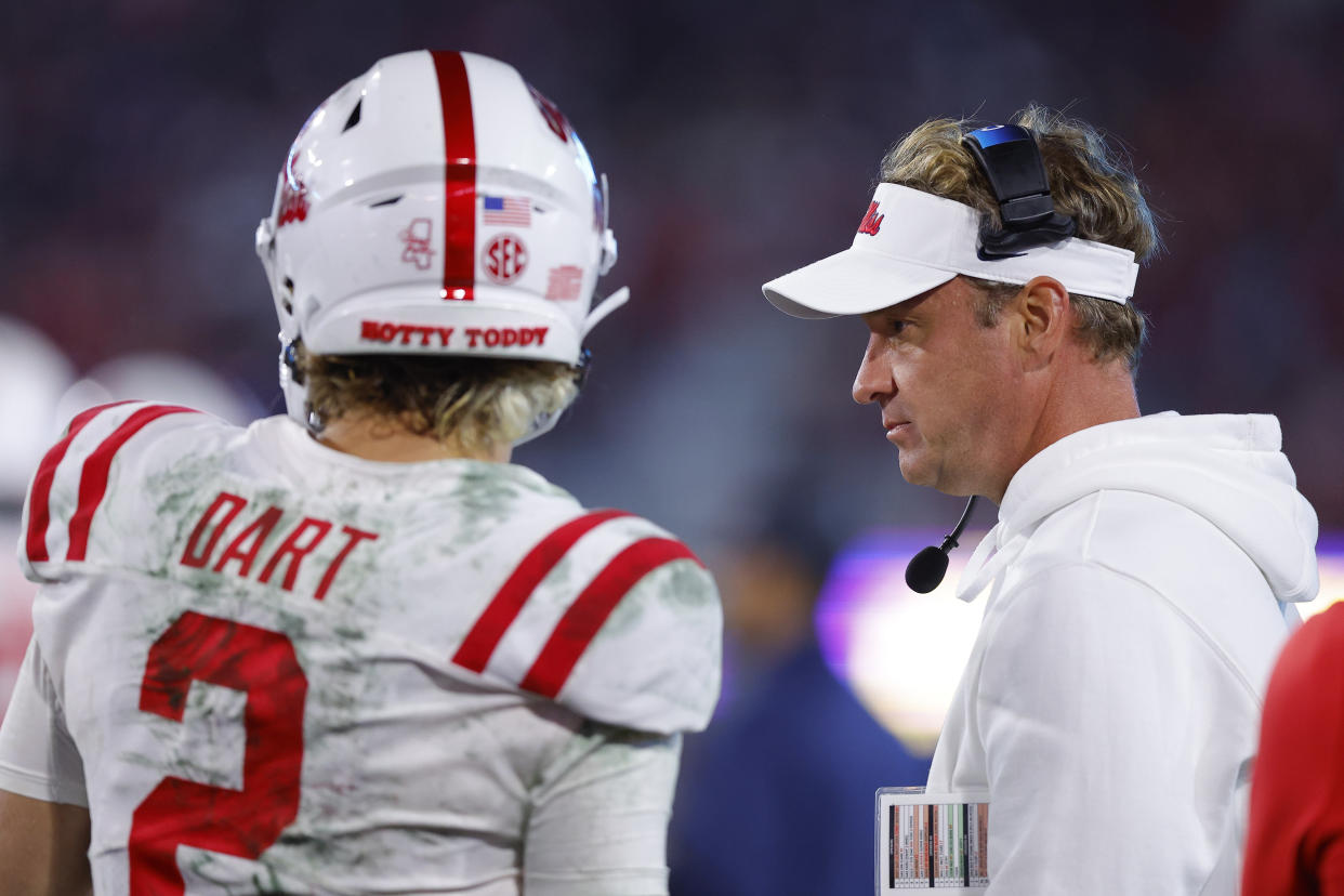 ATHENS, GEORGIA - NOVEMBER 11: Head coach Lane Kiffin speaks with Jaxson Dart #2 of the Mississippi Rebels during the first half against the Georgia Bulldogs at Sanford Stadium on November 11, 2023 in Athens, Georgia. (Photo by Todd Kirkland/Getty Images)