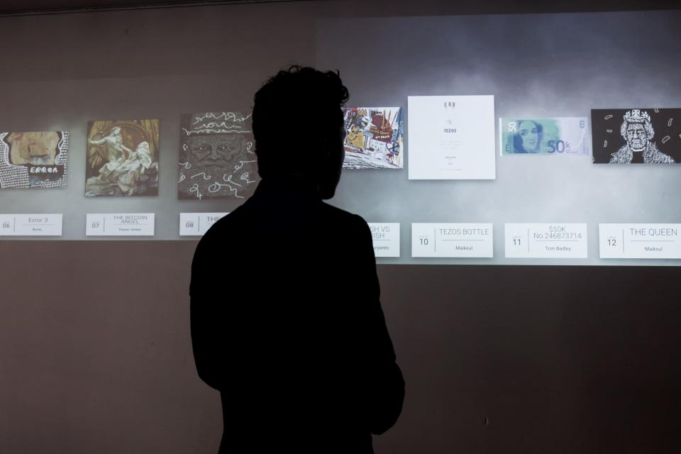 A visitor looks at an 'NFT digital artwork' which will be auctionned on May 20 at the Millon Belgique auction house, in Brussels on May 18, 2021. - After the memorable sale by Christie's for $69 million in March of a collage of 5,000 digital images stamped by the American artist Beeple, the Europeans are getting into the NFT act, which is very speculative, as it is directly linked to the cryptocurrency market. - RESTRICTED TO EDITORIAL USE - MANDATORY MENTION OF THE ARTIST UPON PUBLICATION - TO ILLUSTRATE THE EVENT AS SPECIFIED IN THE CAPTION (Photo by Kenzo TRIBOUILLARD / AFP) / RESTRICTED TO EDITORIAL USE - MANDATORY MENTION OF THE ARTIST UPON PUBLICATION - TO ILLUSTRATE THE EVENT AS SPECIFIED IN THE CAPTION / TO GO WITH AN AFP STORY BY FRANCOISE MICHEL - RESTRICTED TO EDITORIAL USE - MANDATORY MENTION OF THE ARTIST UPON PUBLICATION - TO ILLUSTRATE THE EVENT AS SPECIFIED IN THE CAPTION (Photo by KENZO TRIBOUILLARD/AFP via Getty Images)