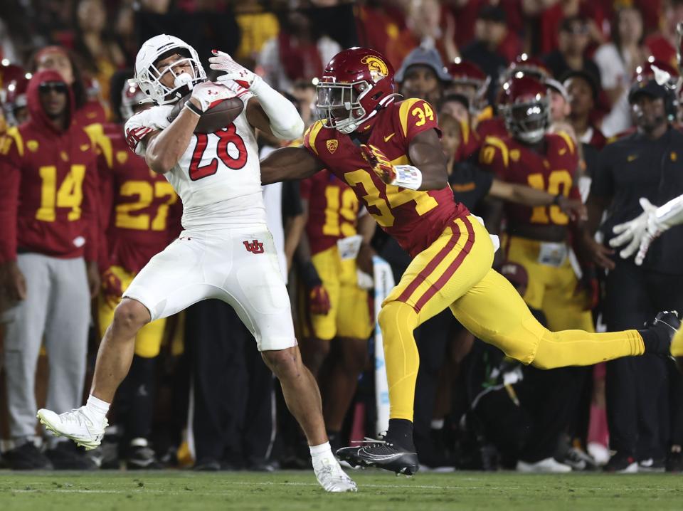 Utah Utes safety Sione Vaki (28) hauls in a pass before getting tackled by USC Trojans defensive end Braylan Shelby (34) at the Los Angeles Memorial Coliseum on Saturday, Oct. 21, 2023. | Laura Seitz, Deseret News