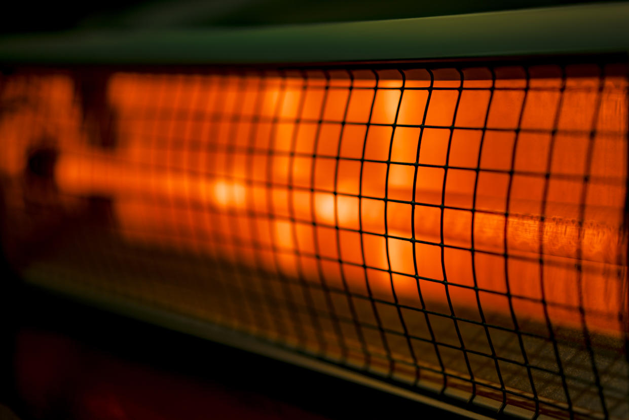 Close up of portable electric halogen space heater on black background