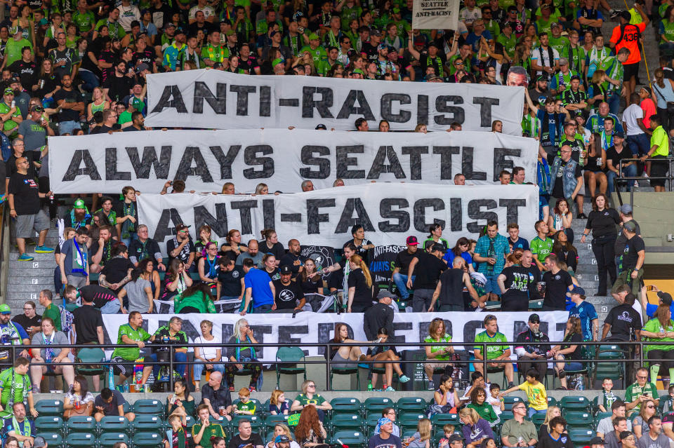 PORTLAND, OR - AUGUST 23: Seattle Sounders supporters group ECS (Emerald City Supporters) remained silent for the first 33 minutes of the game to denounce MLS stand on the iron front symbol during the Seattle Sounders 2-1 victory over the Portland Timbers at Providence Park on August 23, 2019 in Portland, OR (Photo by Diego Diaz/Icon Sportswire via Getty Images).