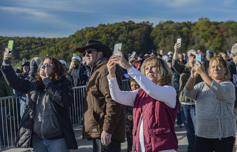 FILE - Fans of Bridge Day document the action during the annual Bridge Day festival in Fayetteville, WVa., on Saturday Oct. 19, 2019. West Virginia's largest annual festival will require most people in attendance to wear masks when Bridge Day is held on Oct. 16, 2021, amid the coronavirus pandemic in American's newest national park. (F. Brian Ferguson/Charleston Gazette-Mail via AP, File)