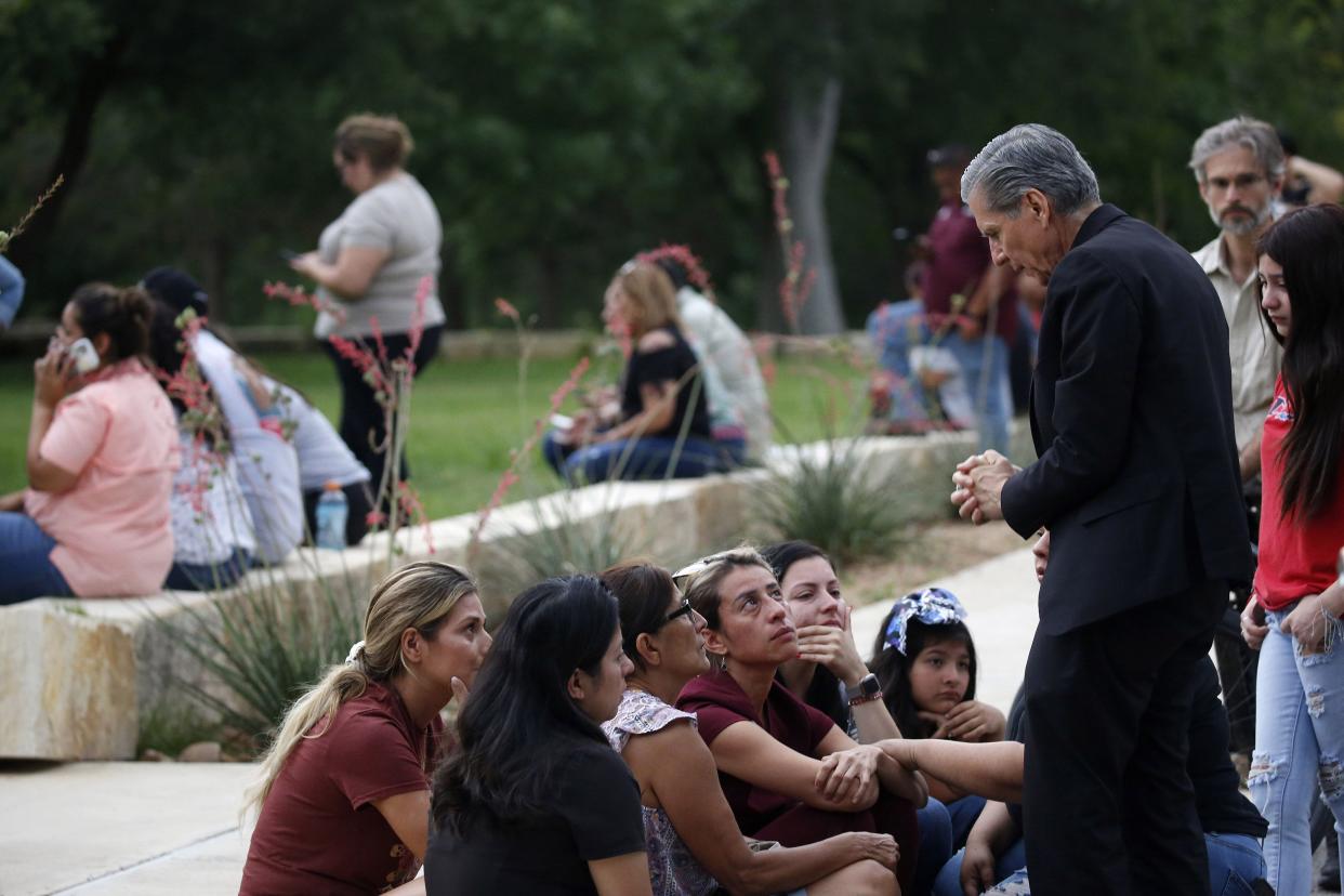 The archbishop of San Antonio, Gustavo Garcia-Siller, right, comforts families outside the Civic Center following a deadly school shooting at Robb Elementary School in Uvalde, Texas on Tuesday, May 24, 2022.