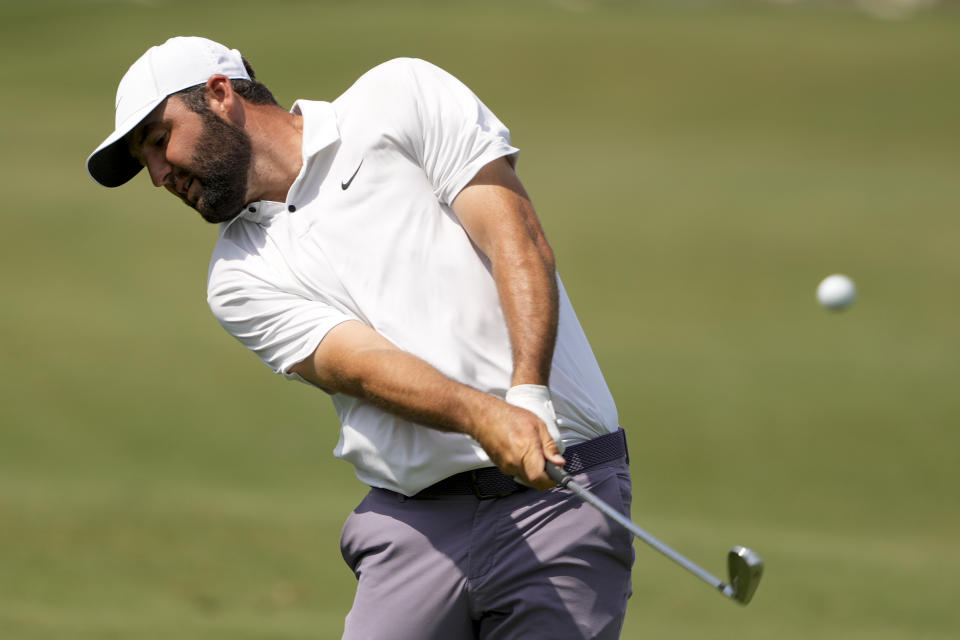 Scottie Scheffler holds the trophy after winning on the 10th hole during the third round of the RBC Heritage golf tournament, Saturday, April 20, 2024, in Hilton Head Island, S.C. (AP Photo/Chris Carlson)