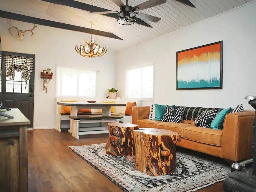 Western-themed sitting room with a couch and log cabin table