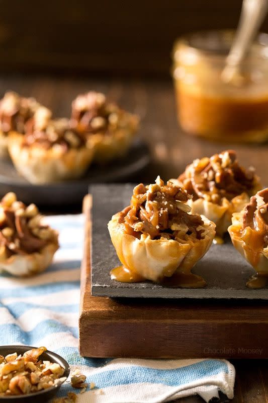 <p>Chocolate Moosey</p><p>Looking for a bite-sized dessert to share with family and friends? These easy-to-serve no-bake turtle cheesecake phyllo cups with chocolate, caramel and pecans will be a popular hit!</p><p><strong>Get the recipe: <a href="https://www.chocolatemoosey.com/2016/11/28/no-bake-turtle-cheesecake-phyllo-cups/" rel="nofollow noopener" target="_blank" data-ylk="slk:Turtle Cheesecake Phyllo Cups;elm:context_link;itc:0;sec:content-canvas" class="link "><em>Turtle Cheesecake Phyllo Cups </em></a></strong></p>