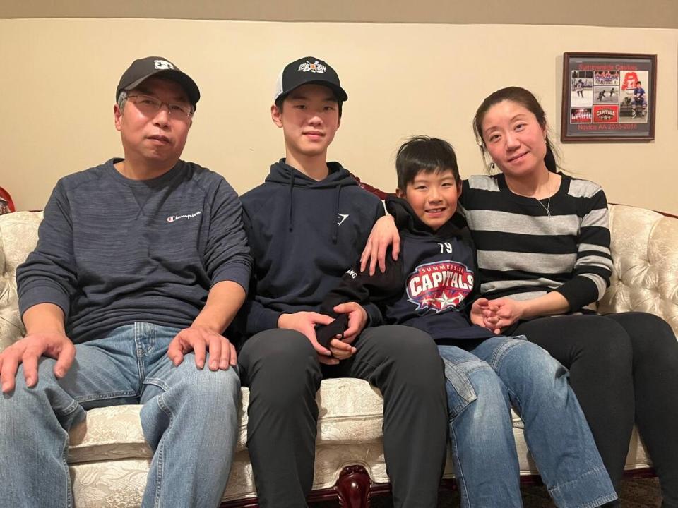 Yang, Marek and Lucy Zhang say they are counting down the days until they can cheer for Brian Zhang (second from left) as he competes on the men's ice hockey team at the 2023 Canada Games.  (Brittany Spencer/CBC - photo credit)