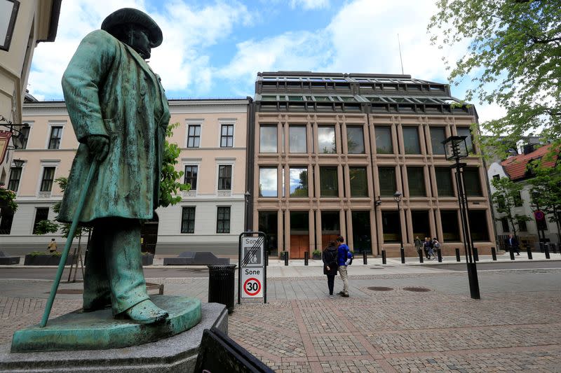 FILE PHOTO: People go about their day near Norway's central bank building in Oslo