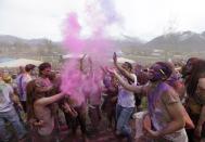 Revelers throw colored corn starch in the air while celebrating during the 2014 Festival of Colors, Holi Celebration at the Krishna Temple Saturday, March 29, 2014, in Spanish Fork, Utah. Nearly 70,000 people are expected to gather starting Saturday at a Sri Sri Radha Krishna Temple in Spanish Fork for the annual two-day festival of colors. Revelers gyrate to music and partake in yoga during the all-day festival, throwing colored corn starch in the air once every hour. The Salt Lake Tribune reports that the large majority of participants are not Hindus, but Mormons. Thousands of students from nearby Brigham Young University come to take part in a festival that is drug and alcohol free. The event stems from a Hindu tradition celebrating the end of winter and the triumph of good over evil. (AP Photo/Rick Bowmer)