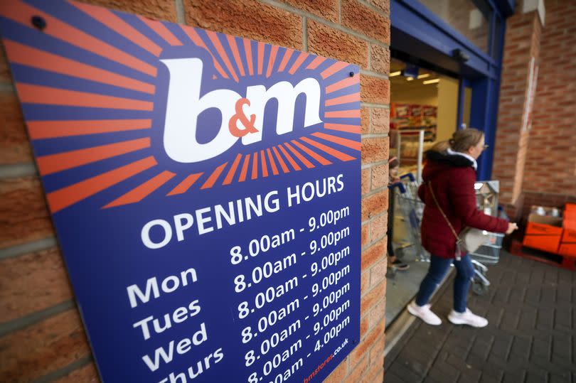 A customer exits a B&M Bargains store