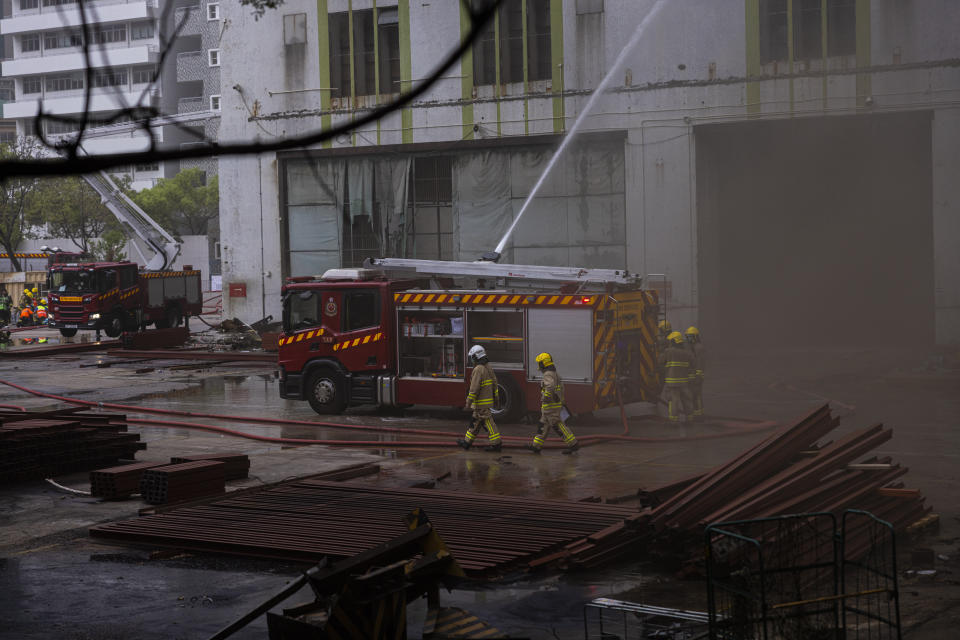 Firefighters battle a fire in Cheung Sha Wan, a residential and industrial area, in Hong Kong, Friday, March 24, 2023. Hong Kong firefighters were battling a blaze Friday at a warehouse that forced more than 3,000 people to evacuate, including students, police said. (AP Photo/Louise Delmotte)