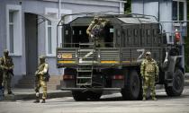 Russian soldiers guard an area as a group of foreign journalists visit in Kherson, 20 May