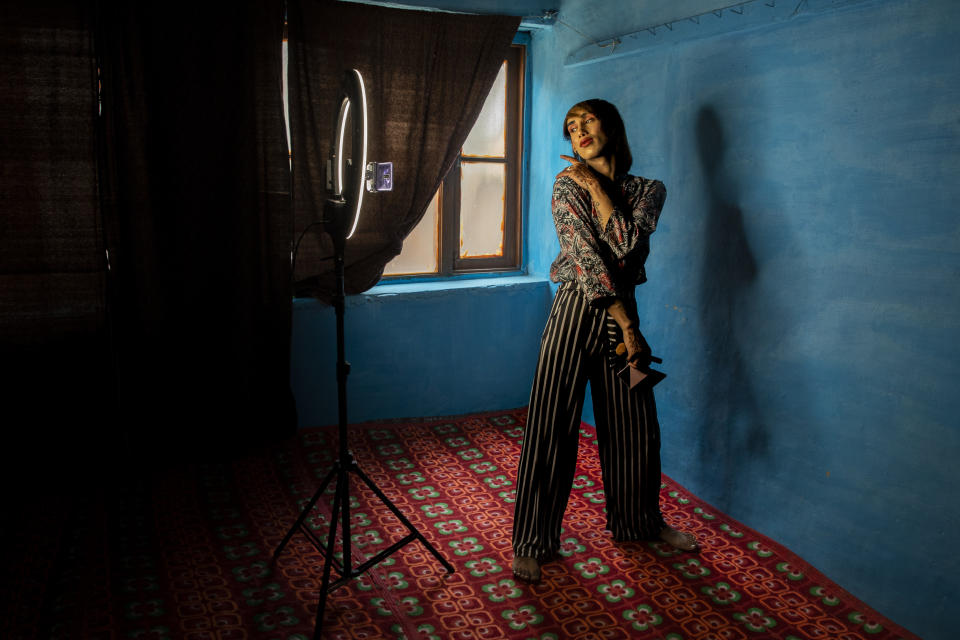 A transgender Kashmiri Manu Babo makes an instagram video at home in Srinagar, Indian controlled Kashmir, Wednesday, June 9, 2021. Babo is a 19-year-old self-taught make-up artist living who is bending the rules of conservative Kashmiri society. Her instagram account reads "A Proud Transgender". She received assignments even during the pandemic from her instagram and YouTube accounts. (AP Photo/ Dar Yasin)