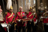 The Imperial State Crown is carried through the Norman Porch at the Palace of Westminster and the Houses of Parliament at the State Opening of Parliament ceremony in London, Monday, Oct. 14, 2019. (AP Photo/Matt Dunham, Pool)