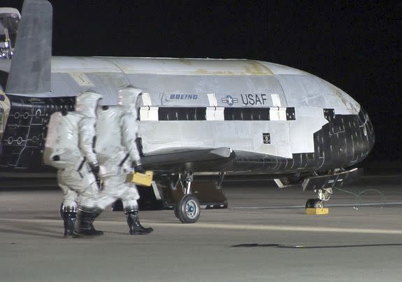 The Air Force's X-37B Orbital Test Vehicle sits on a runway after visiting space.