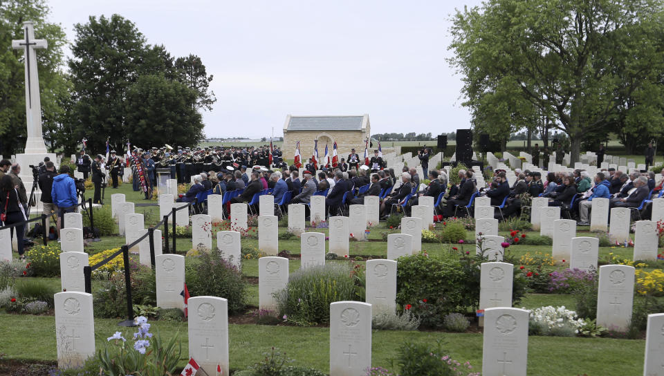 Canadian World War II veterans and other guests attend a commemoration ceremony at the Beny-sur-Mer Canadian War Cemetery in Reviers, Normandy, France, Wednesday, June 5, 2019. A ceremony was held on Wednesday for Canadians who fell on the beaches and in the bitter bridgehead battles of Normandy during World War II. (AP Photo/David Vincent)
