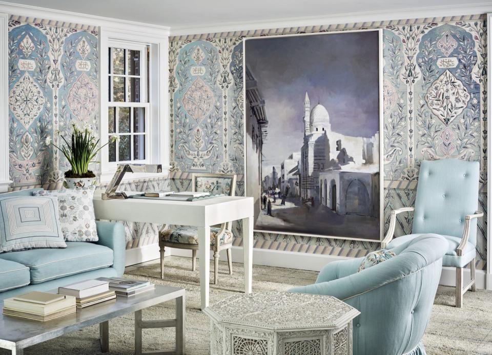 a blue and white room with mosaic tile looking wallpaper and an overscale photo on the wall