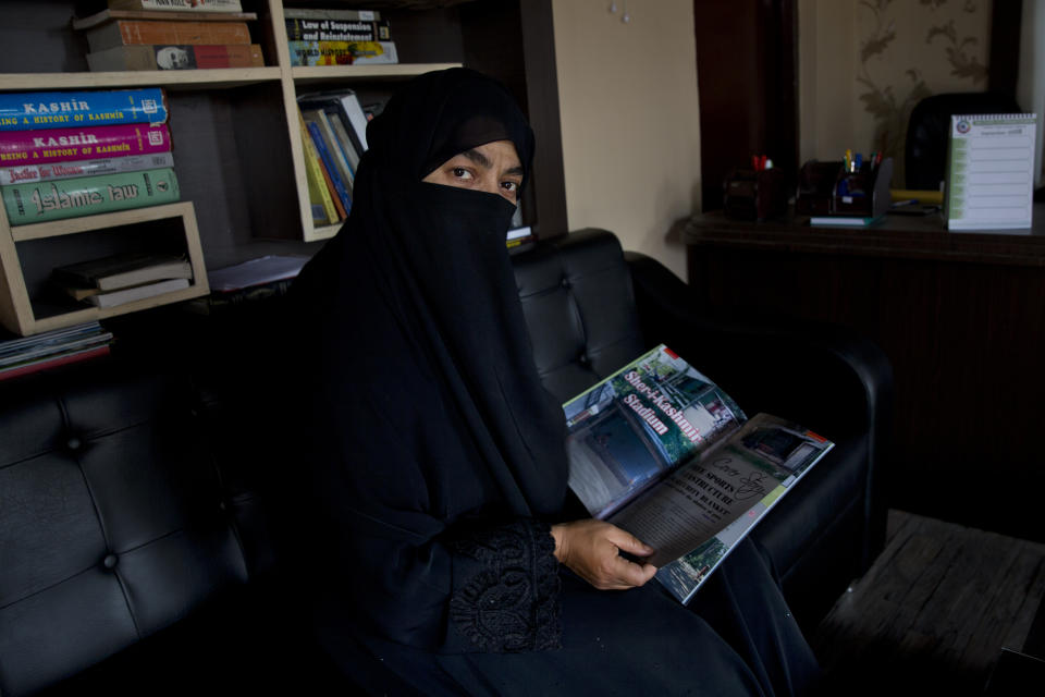In this Wednesday, Sept. 25, 2019, photo, Sahana Fatima, the first female entrepreneur in printing who runs the only sports magazine in the Kashmir valley, sits for a photograph inside her office in Srinagar, Indian controlled Kashmir. Fatima says they were unable to print the August edition due to the blockade. “Even if we had decided to print, what would we write about? There was nothing happening as far as sports activities were concerned. Everything has come to a standstill.”(AP Photo/ Dar Yasin)