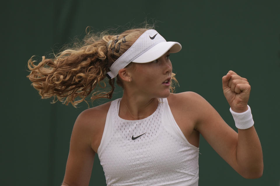 Russia's Mirra Andreeva celebrates winning.a point from Russia's Anastasia Potapova during the women's singles match on day seven of the Wimbledon tennis championships in London, Sunday, July 9, 2023. (AP Photo/Alberto Pezzali)