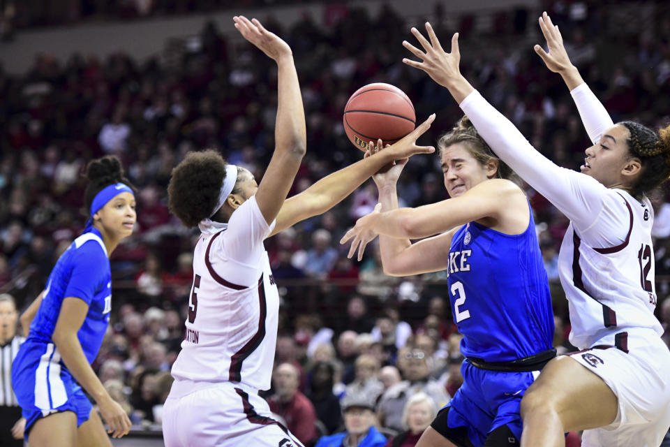 Duke guard Haley Gorecki (2) is defended by South Carolina's Breanna Beal (12) and Victaria Saxton (5) during the first half of an NCAA college basketball game Thursday, Dec. 19, 2019, in Columbia, S.C. (AP Photo/Sean Rayford)