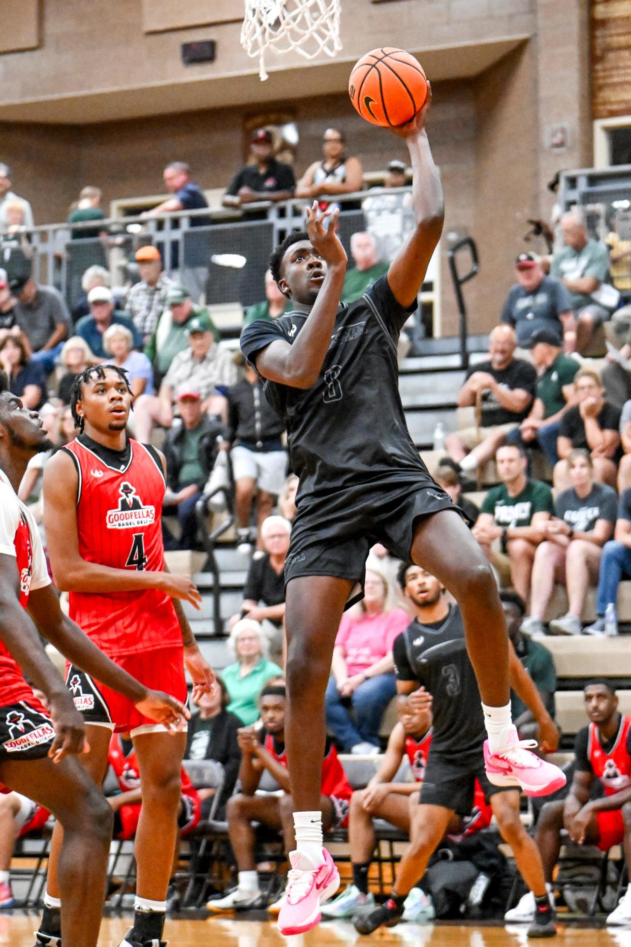 Team Motorcars and Michigan State's Xavier Booker scores against Team Goodfellas in the game on Tuesday, July 9, 2024, during the Moneyball Pro-Am at Holt High School.