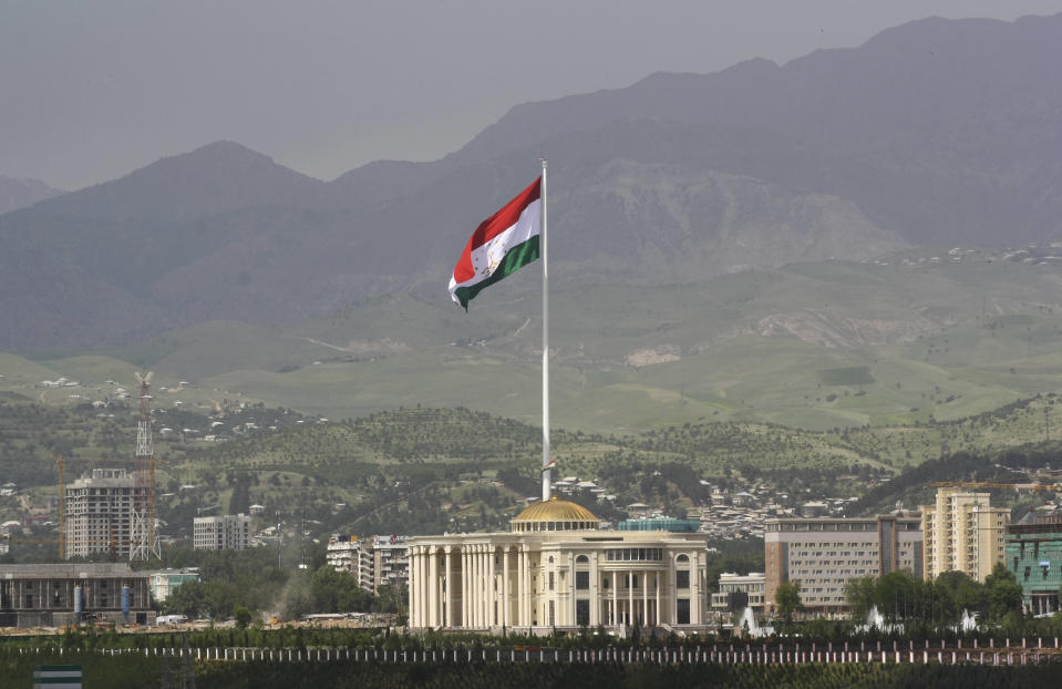 FILE - A national flag of Tajikistan is hoisted to the top of the 165-meter (541.34 feet) flagpole in Dushanbe, Tajikistan, Tuesday, May 24, 2011. The four men charged with the massacre at a Moscow theater have been identified by the Russian government as citizens of Tajikistan, some of the thousands who migrate each year from the poorest of the former Soviet republics to scrape out marginal existences. (AP Photo/Olga Tutubalina, File)