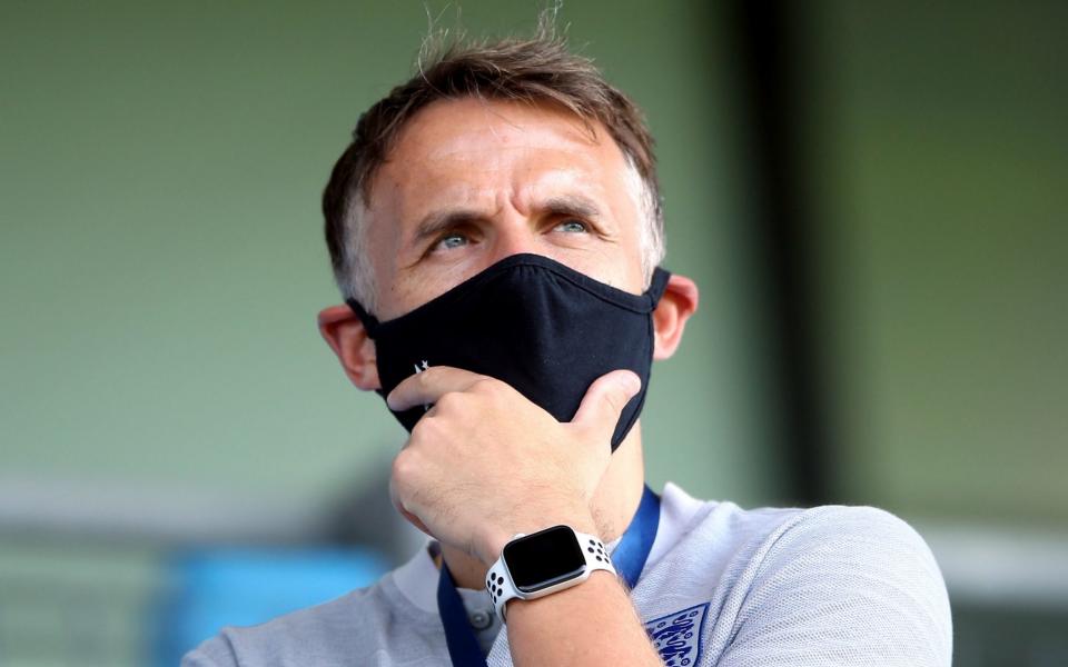 Phil Neville in mask - Nick Potts/PA Wire